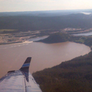 Aerial photograph of the Muskrat Falls site. Lower falls are at the wing tip.  The hill to the right of the falls is known as the Rock Knoll. 