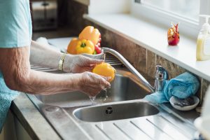 Washing peppers at the sink.