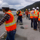 Representatives of the Independent Engineer, the Government of Canada, EandY, the Government of Newfoundland and Labrador, and Nalcor standing on the RCC Cofferdam.  