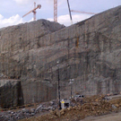 Powerhouse excavation, cranes visible at the top of the excavation are working on the adjacent spillway