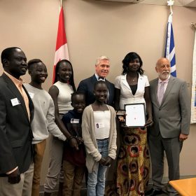 The Honourable Dwight Ball, Premier of Newfoundland and Labrador, the Honourable Al Hawkins, Minister of Advanced Education, Skills and Labour, and Council of the Federation Literacy Award recipient, Ms. Suna Dau Yath, and her family.