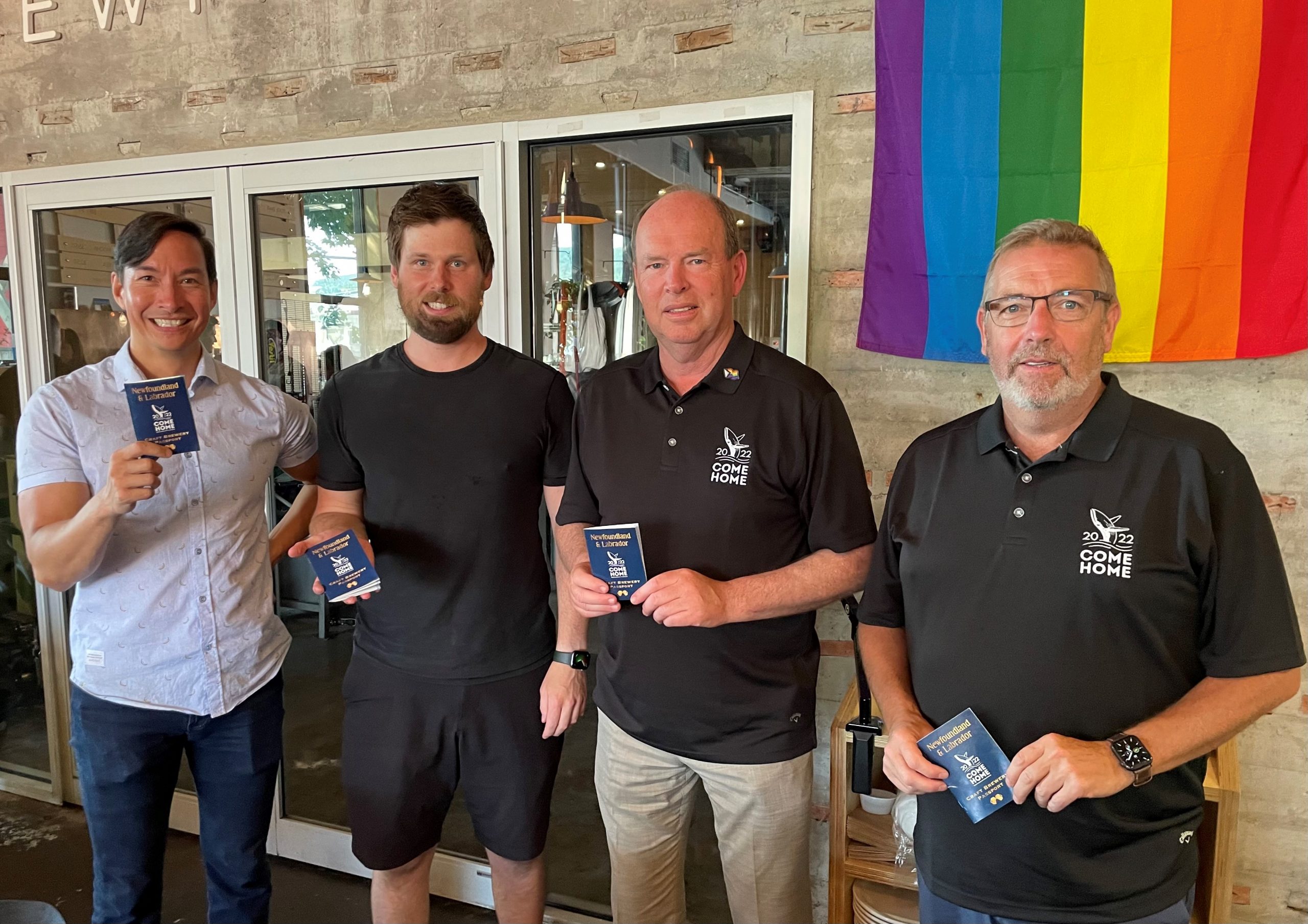 Minister Steve Crocker, Minister John G. Abbott, Justin Fong of Quidi Vidi Brewery and Phil Maloney of Bannerman Brewery showing their Come Home 2022 Craft Brewery Passports