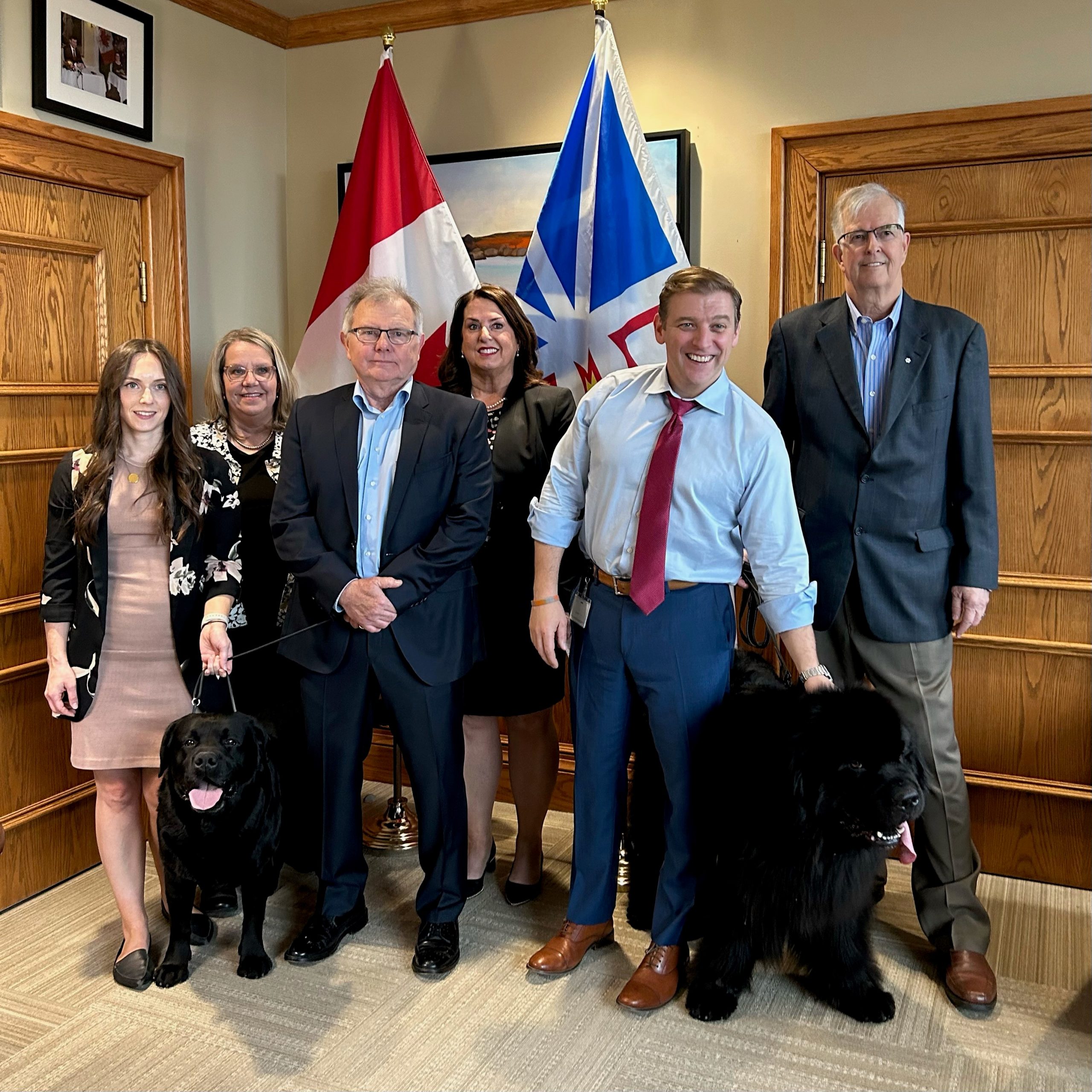 Beau, the Labrador Retriever, and Night, the Newfoundland dog, met with the Premier today. From left to right: Caitlin O’Brien-Dyke, Pamela Squires, Pat Coady, the Honourable Siobhan Coady, the Honourable Dr. Andrew Furey, and Rob Crosbie.
